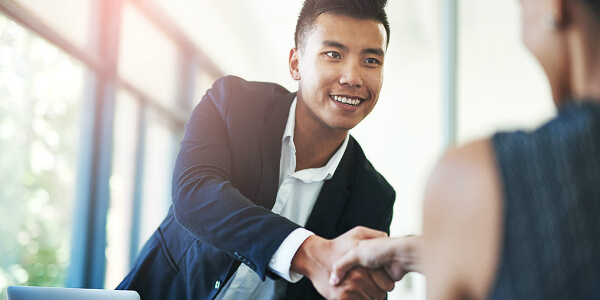 Asian man shaking hands after discussing a continuation plan