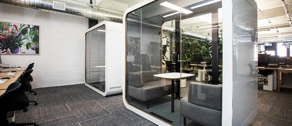 Office space with two clear pods 