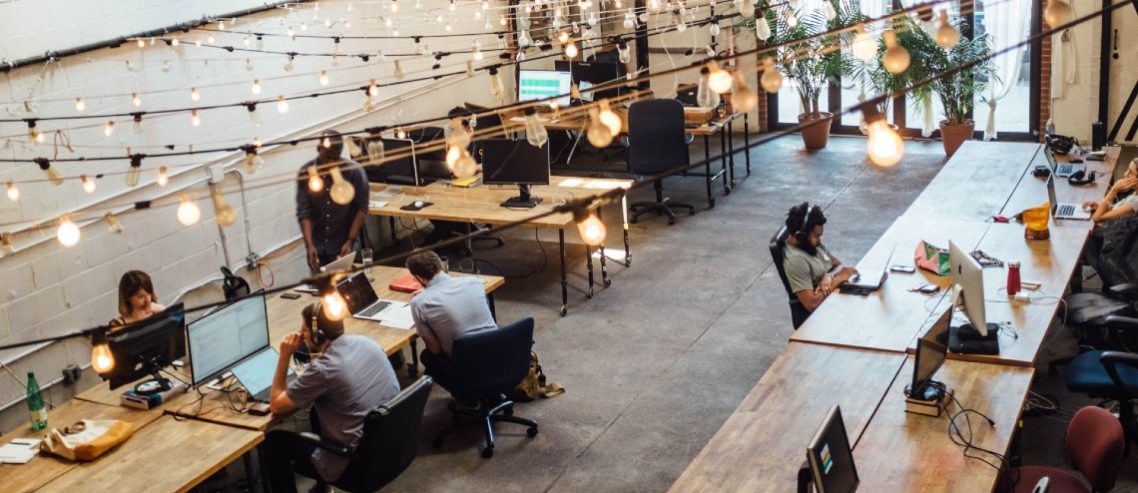 young professionals using five productivity life hacks in a co-working space