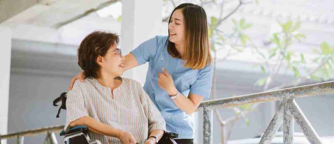 A woman and older woman talking and smiling in the hospital