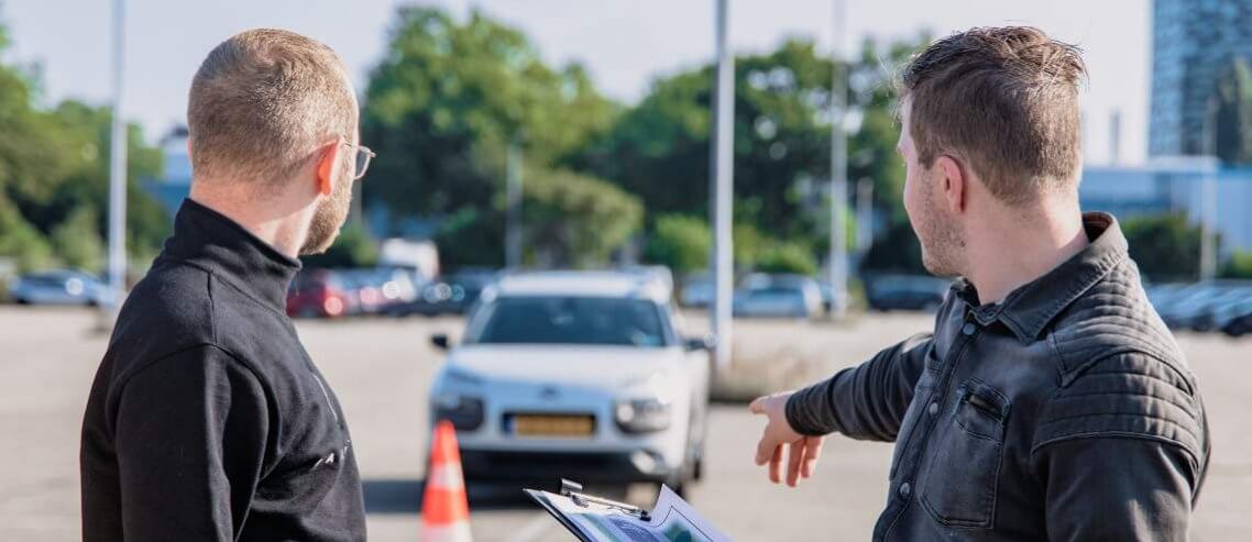 Driver instructor and student having a conversation