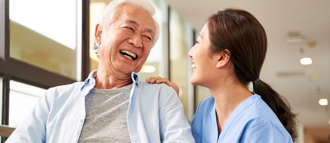 Hospital employee helping Elderly patient in Singapore