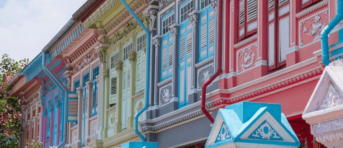 red and white concrete building under white clouds during daytime