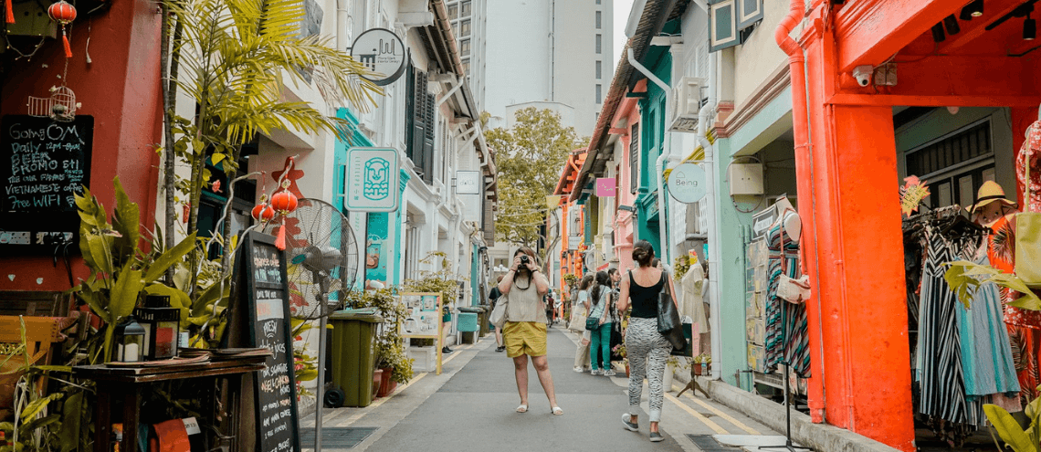 tourist taking a photo in the local street in singapore