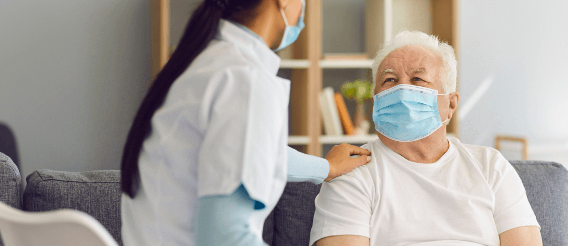 A doctor with a sick old man in a hospital