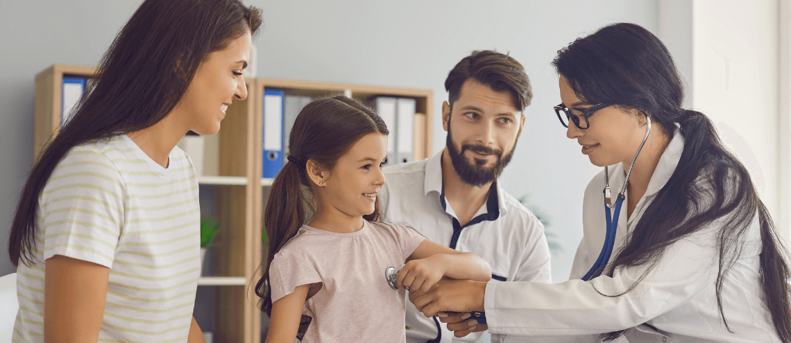 a family with a doctor and a doctor is checking a child's health in a hospital room